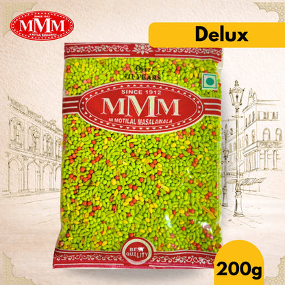 Bag of MMM (Motril Masalawala) delux mukhwas with brand logo and 'Delux' label on a decorative background.